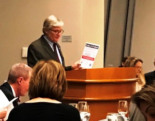 Andy Branham, Co-chair of the TBA Corporate Counsel Committee, holds up a flyer promoting #HELP4TNDAY, kicking off March 21 in Memphis, Jackson, Nashville, Chattanooga and Knoxville.