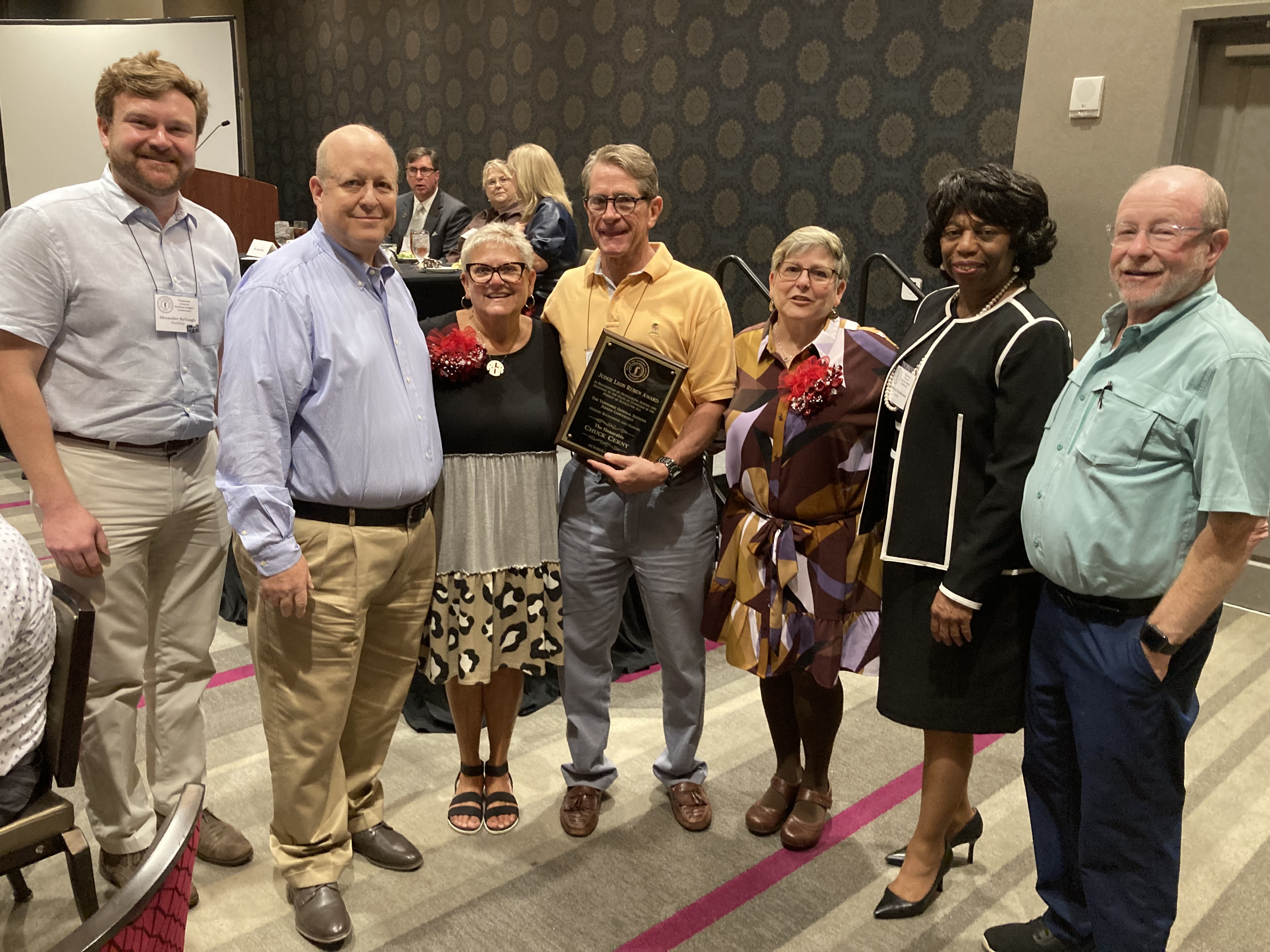 Judge Chuck Cerny surrounded by the daughters and sons-in-law of the late Judge Leon Ruben; Hamilton County General Sessions Court Judge Alex McVeagh; and outgoing General Sessions Judges Conference President and Shelby County General Sessions Judge Deborah Means Henderson.